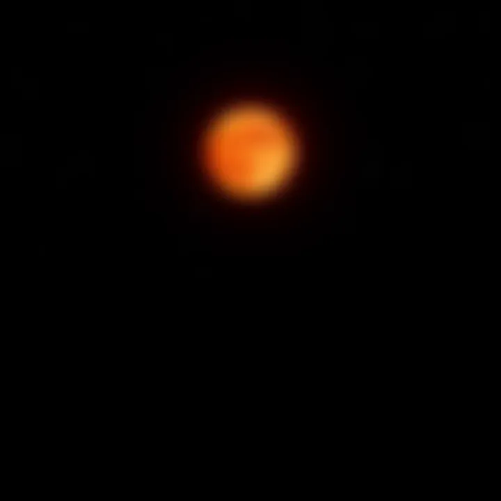 A bright Blood Moon glowing in the dark sky, surrounded by scattered stars