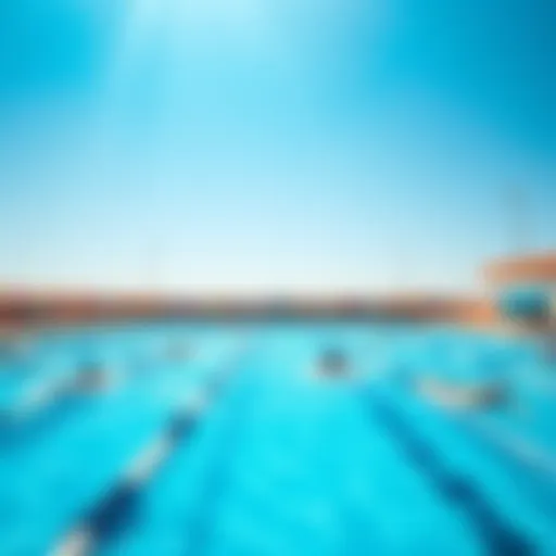 A clean public pool with people swimming and enjoying the water under a clear blue sky.