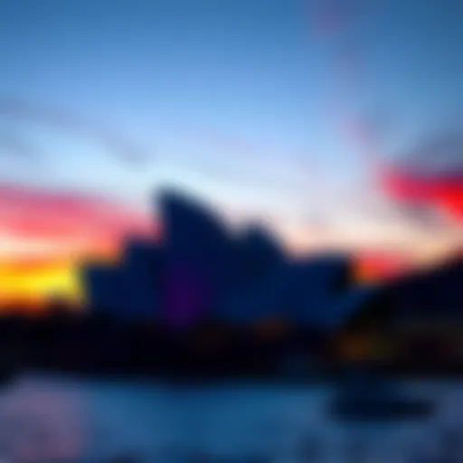 The Sydney Opera House silhouetted against a vibrant sunset sky over the harbor.